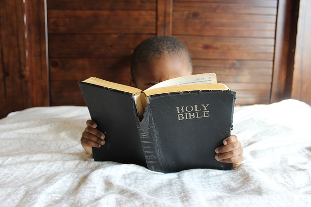 Boy reading Bible. 