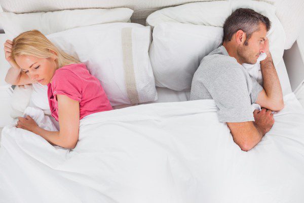 couple in bed not talking