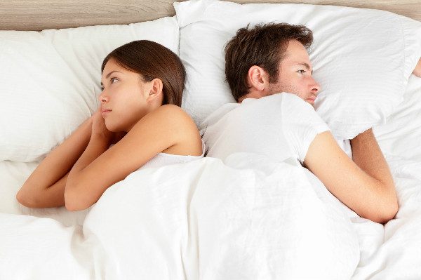 couple in bed frustrated