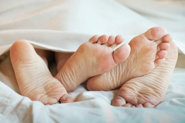 couple in bed feet