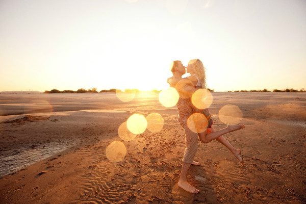 couple beach hug