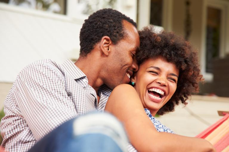 laughing couple cuddling