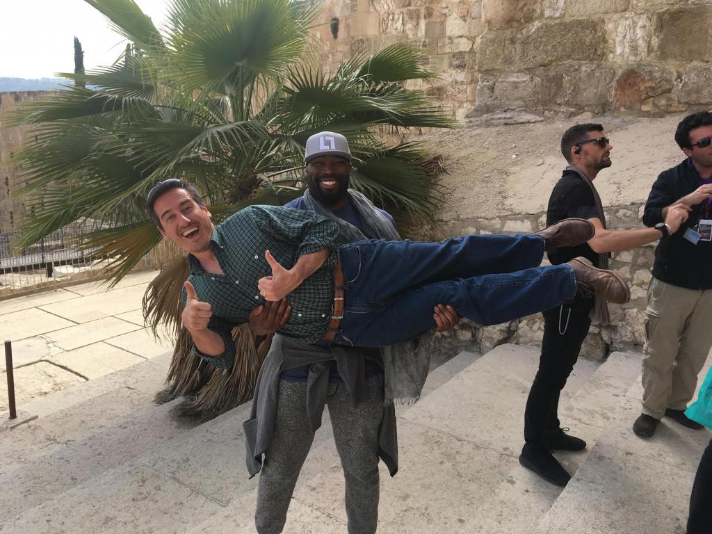 Being lifted up BY Israel IN Israel. Former NFL player Israel Idonije with Joel Smallbone from the band "For King and Country" in the background.