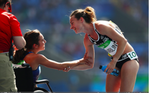  New Zealand's Nikki Hamblin helps American runner, Abbey D'Agostino, after she falls during the 5,000 meter preliminary race.  