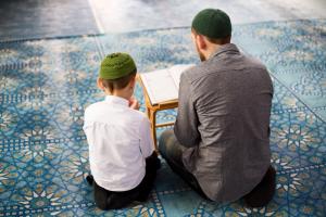 Father teaches son to read the Quran