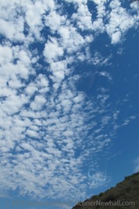 A mighty streak of puffy white clouds streams across the Los Angeles, CA, sky. Photo by Barbara Newhall