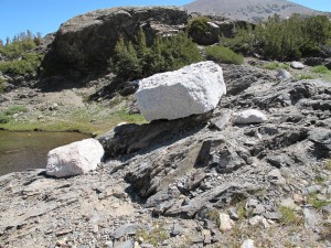 Something to meditate on: a Glacial erratic rock is perched tentatively on a lakeside slope at Inyo National Forest.  Photo by Barbara Newhall