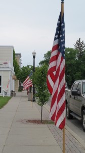 The American flag flies on a main street in the Midwest. Give last-minute gifts of patriotism. Photo by Barbara Newhall