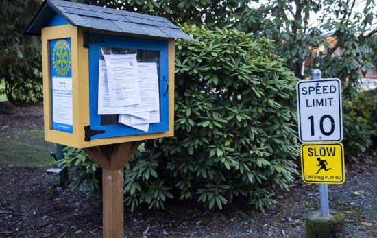 Community notices are posted on a small library at the entrance to the Sherwood Village community.