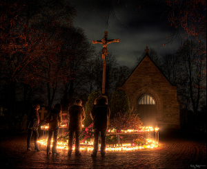 In some parts of the world Christians go to graveyards to pray and place flowers and candles on their loved one’s graves on All Hallow’s Eve. This picture depicts the holy day (holiday) in Sweden.