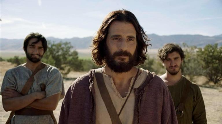 Actors portraying James the Greater, Jesus and John stand in a desert landscape.