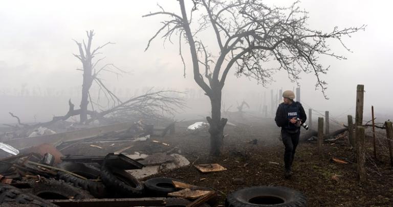 A war correspondent walks through a bombed-out wasteland.