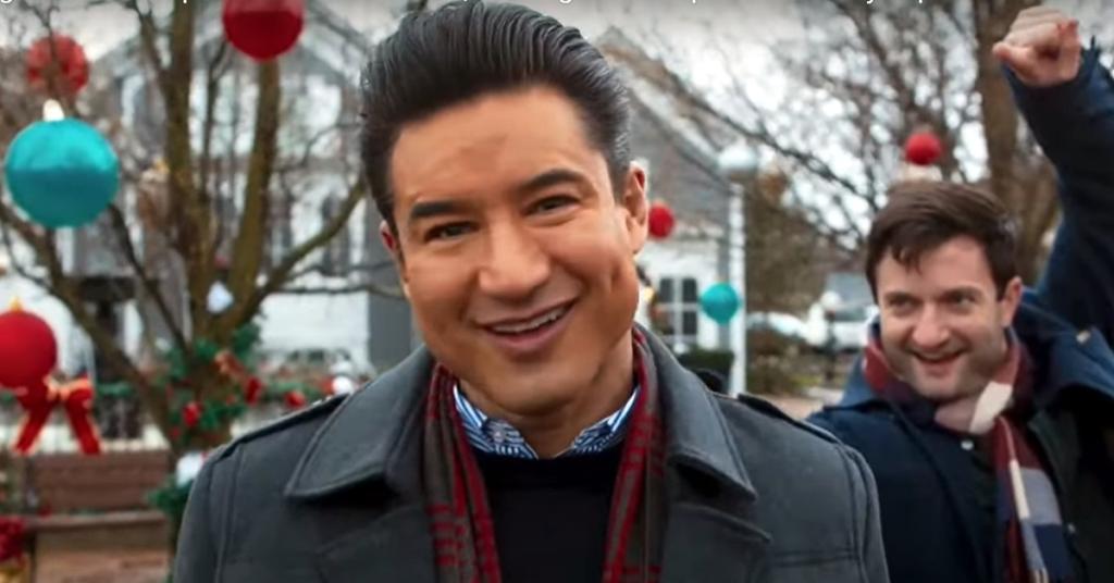 A smiling actor working on a Christmas movie.