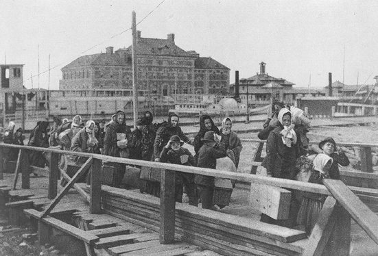 https://commons.wikimedia.org/wiki/File%3AEllis_island_1902.jpg; See page for author [Public domain], via Wikimedia Commons