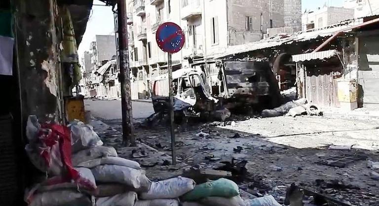 https://commons.wikimedia.org/wiki/File%3ABombed_out_vehicles_Aleppo.jpg; By Voice of America News: Scott Bobb reports from Aleppo, Syria [Public domain], via Wikimedia Commons