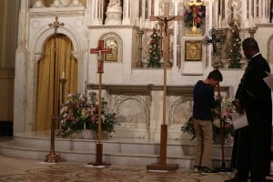 photo of four crosses on a Roman Catholic altar, including a crucifix and Coptic cross