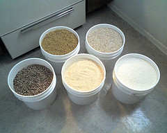five bulk containers of flour and other dry goods