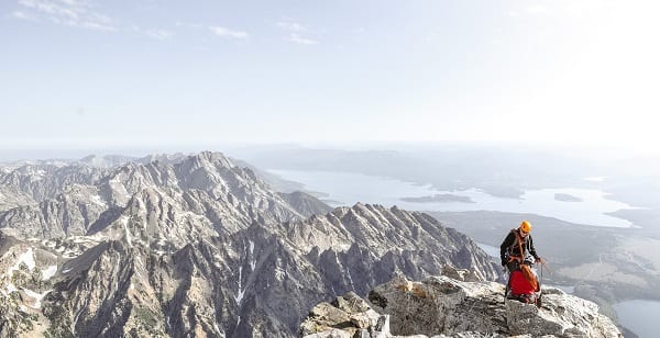 two climbers atop a high mountain peak