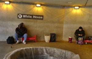 For use with Inequality-WashingtonDC/ special report Homeless men hang around the entrance to the Metro close to the White House early Christmas morning in Washington, in this December 25, 2011 file photo. REUTERS/Larry Downing (UNITED STATES)