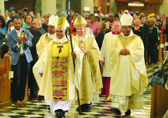 New Orleans Auxiliary Bishop Cheri walks with his crosier following episcopal ordination Mass