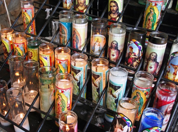 Votive_candles_at_a_roadside_grotto_in_north_Texas