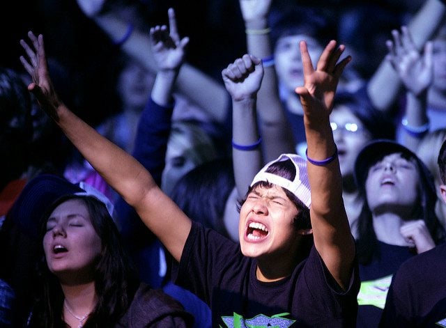 Jonathan Navaro, 15, of Kenosha, Wis., raises his hands in worship at the Convention Center, in La Crosse, Wis., on Friday October 30, 2009. These students were part of the 1700 youth that attended the Assemblies of God denomination Youth Convention for Wis. and UP of Mich. for the weekend. An evangelist, Jason Maupin, had just finished speaking, and whey were some of the several hundred that come forward to a stage area to pray, and had a desire to grow closer in their relationship with God. (AP PHOTO/The Country Today/Paul M. Walsh)