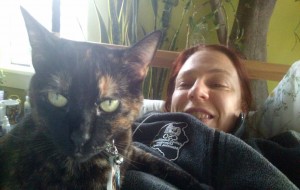 Smiling despite being in bed with Con Crud. Also, cats make everything better. Especially Ronja, because she is an awesome cat. 