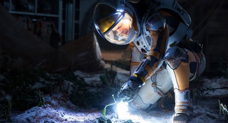 Mark Watney in an EVA suit looking at his frozen plants