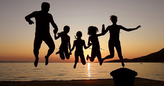 family jumping at sunset 550x290