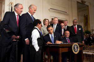 Then President Obama signing the Patient Protection and Affordable Care Act on March 23, 2010. Public Domain by Pete Souza.