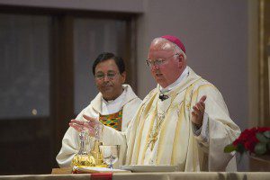 Bishop Patrick Joseph McGrath consecrating the Sacraments at Saint Albert the Great Church in Palo Alto, California. Photo by Frederick Manligas Nacino. (CC BY-SA 3.0)