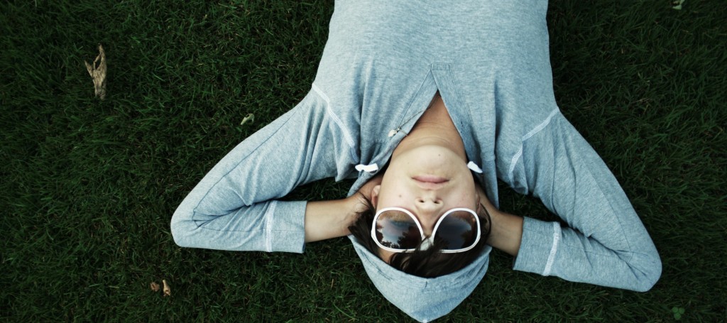 kid lying in grass