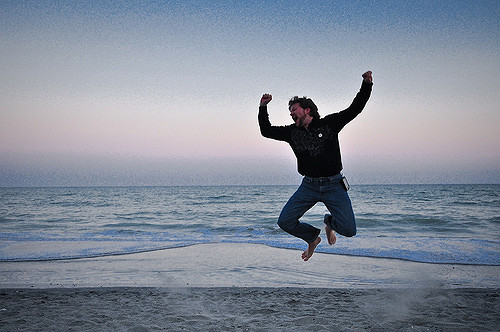 man jumping on beach