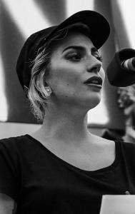 Gaga speaking at a memorial for victims of the Pulse nightclub shooting. Via wikipedia.