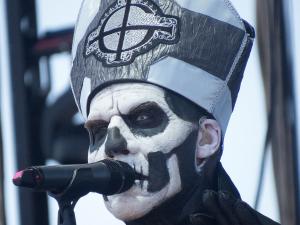 Papa Emeritus of the band ghost. The singer is wearing black and white skeleton facepaint and is wearing a pointed Pope Hat.