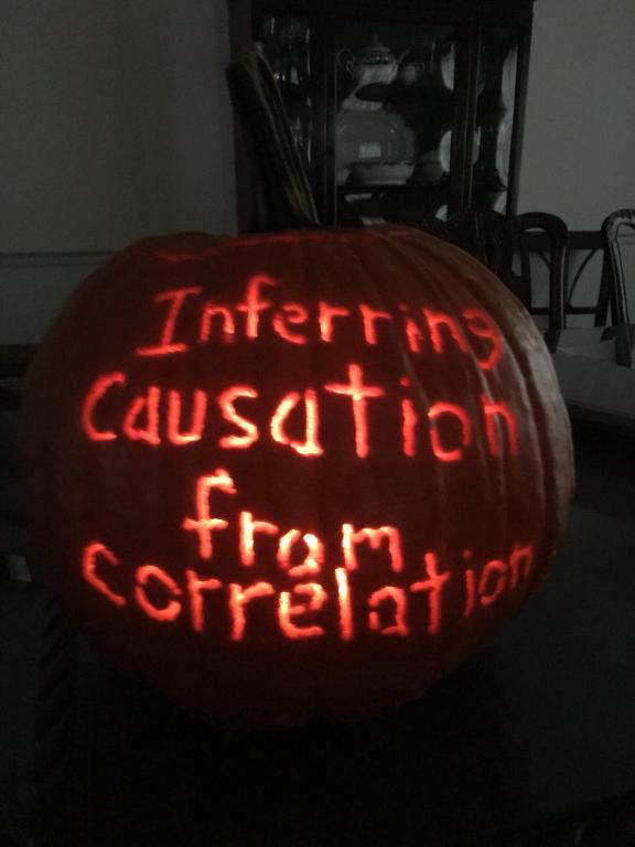 A Jack O' Lantern with "Inferring Causation from Correlation" carved into it