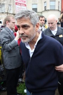 George Clooney is escorted to the police van by the Secret Service Uniformed Division police at a demonstration against the genocidal regime of Sudan in 2012.