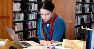 Me in a library... because that's a cool metaphor for curating the narratives of others, right? Photo by James Moriarty.