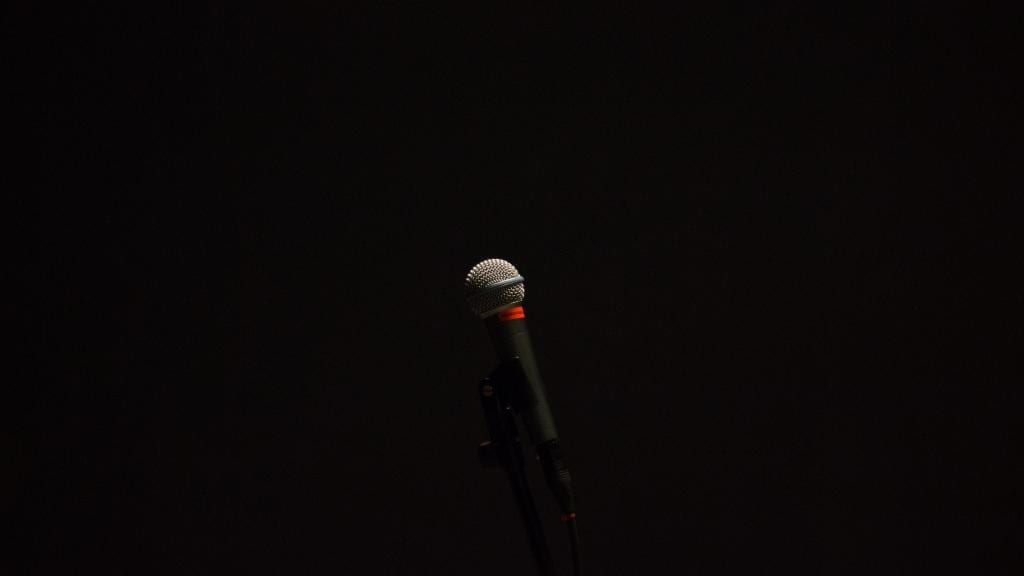 Microphone against a dark background.
