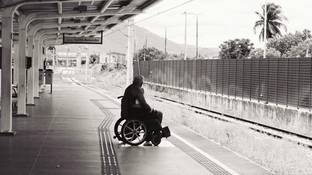 man in a wheelchair, at a metro station