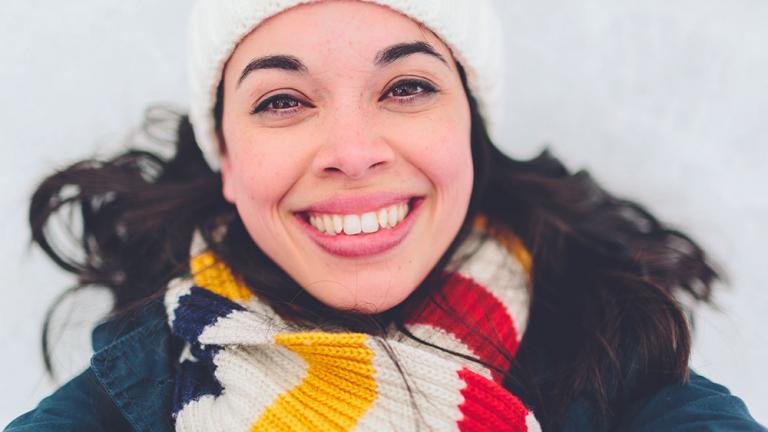 smiling woman in winter hat and scarf