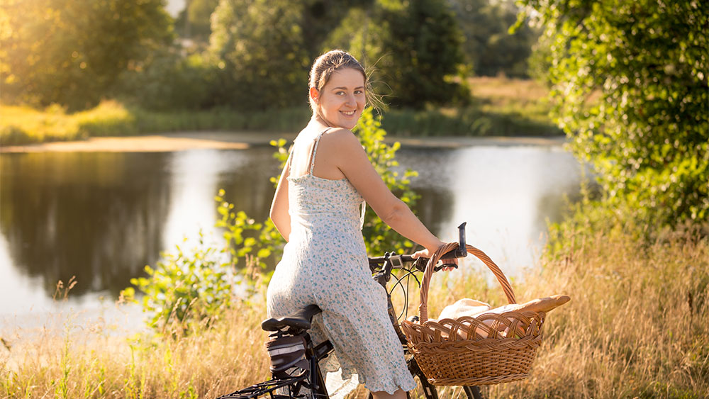 woman cycling by the lake