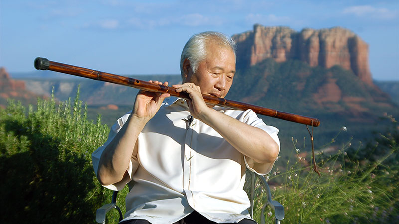 Ilchi Lee playing a staff flute