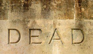 a tomb with the word "DEAD" carved on it