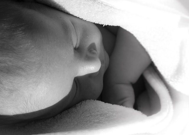 a newborn baby in swaddling cloths