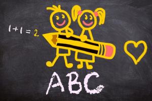 a chalkboard drawing of two school children holding a big pencil, with "ABC" and "1+1=2" and a heart drawn in chalk