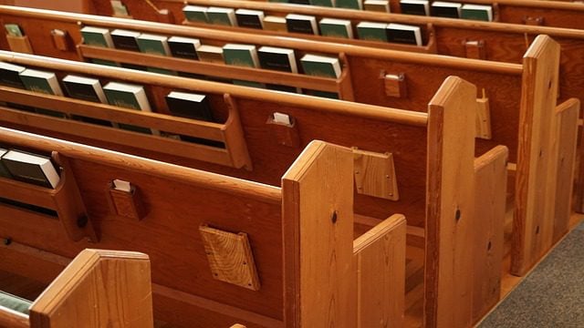 church benches with hymn books