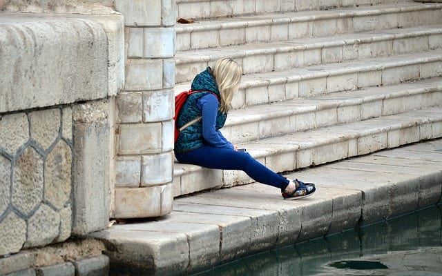 a woman sitting alone on the steps