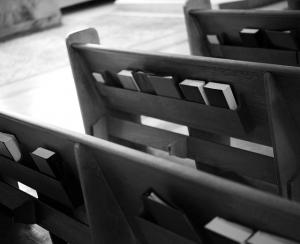 a black and white photograph of church pews