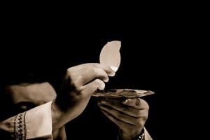 A priest holding the Eucharist